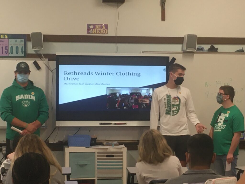 High school students presenting to a grade school class about their clothing drive to benefit ReThreads, a clothing donation center. 