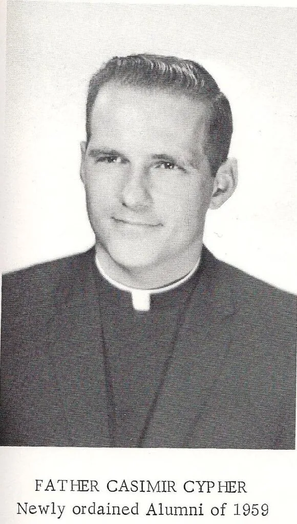 An old black and white photo shows a young Father Casimir Cypher wearing black robes and a clerical collar. There is text below the photo laid out as if it is in a yearbook. The text reads "Father Casimir Cypher Newly ordained Alumni of 1959".