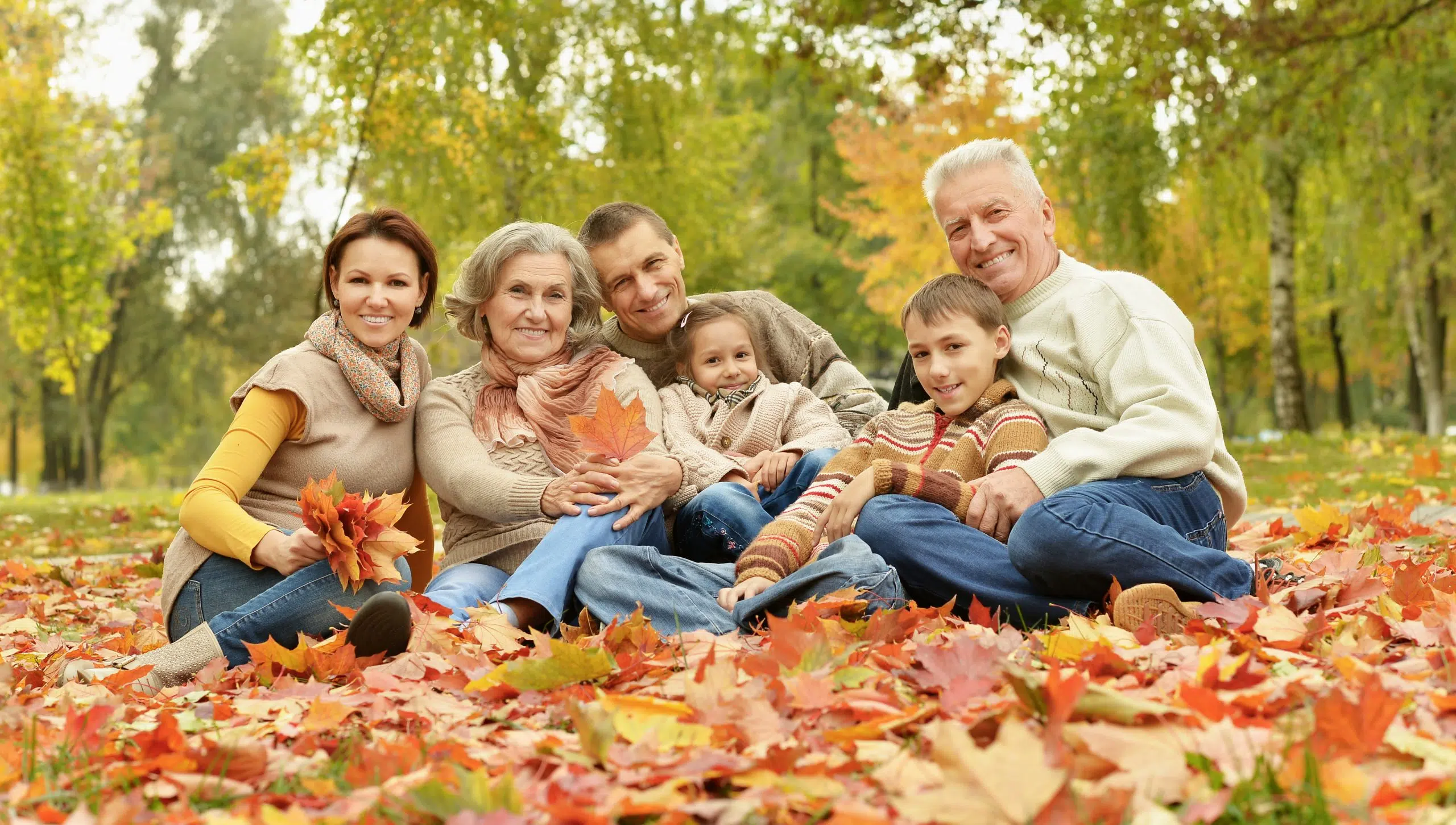A family of five ran through a forest on a bright autumn day